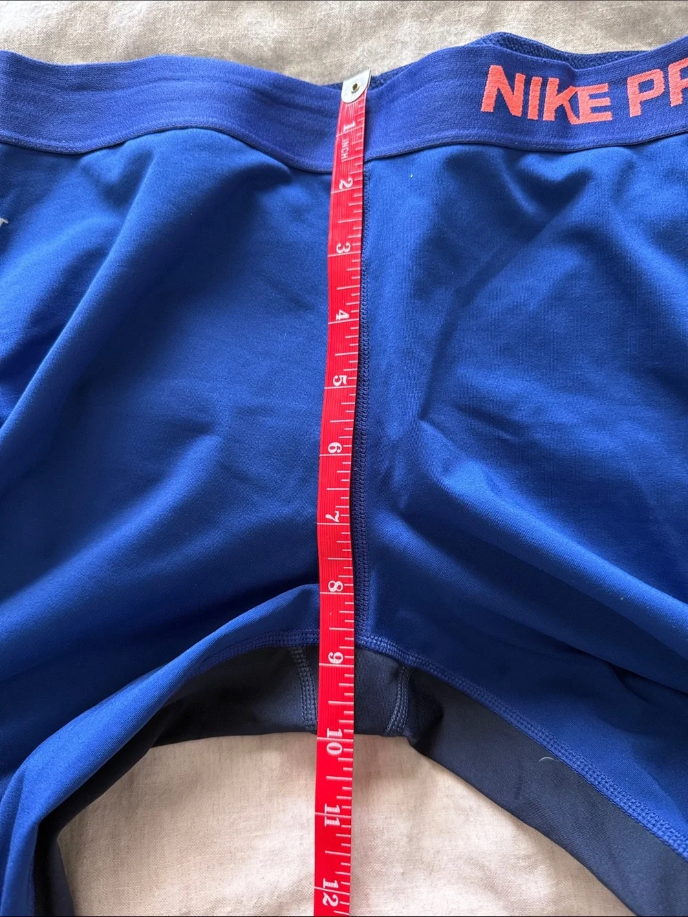 Nike Blue Cropped Leggings with Black Side Panels and Coral Accent